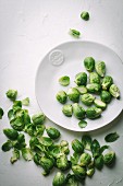 Brussel sprouts on white plate and white background