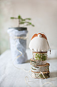 Pottery angel on stack of birch discs