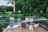 Table set with candles and tealights in garden