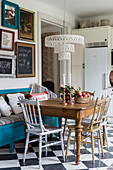 Silver and gold chairs at antique dining table in kitchen