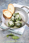 Homemade Canederli with spinach served with butter sage and parmesan cheese