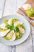 Caprese with green tomatoes and basil