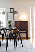 Table, chairs and tall retro sideboard in dining room