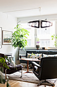 Leather furniture and houseplants in retro-style living room