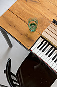 Piano keyboard integrated below dining table