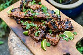 Grilled spare ribs on a wooden chopping board