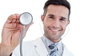 Male doctor holding stethoscope