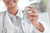 Female doctor holding inhaler