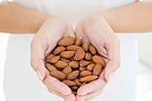 Woman holding almonds in hands