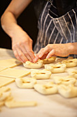 Forming small dumplings from raw dough