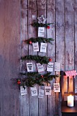 Stylised Christmas tree made from fir branches and decorated with Christmas greetings in various languages