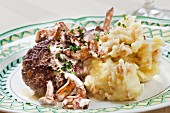 A veal meatball with chanterelle mushrooms and mashed potato