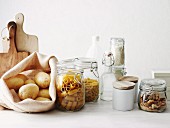 Potatoes, pasta and nuts in storage jars