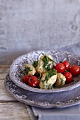 Ground elder quenelles with braised tomatoes