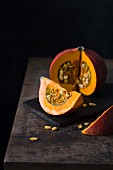 A cut-open pumpkin on a wooden table
