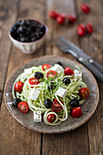 Cucumber spaghetti with feta cheese, olives and tomatoes