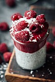 Chia pudding with raspberry and avocado mousse in glass jars