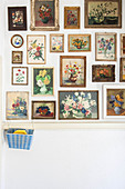 Gallery of framed, floral still-life paintings on white wall