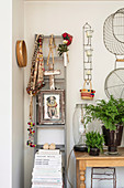 Ladder with ethnic accessories next to a console table with fern