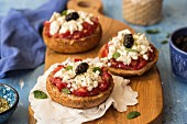 Dakos - a traditional dish from Crete with farmhouse bread, tomatoes, mizithra cheese, black olives and oregano