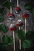 Dark chocolate-coated strawberries on sticks