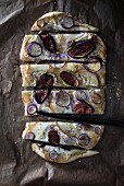 Vegan tarte flambée with figs, pears, red onion and seasoning spices