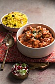 Butter chicken curry with turmeric rice and yoghurt sauce (India)
