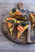 Stinging nettle and vegetable frittata on a wooden board