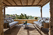 Couches and coffee table on roofed terrace