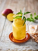 A mango smoothie with mint and lemon