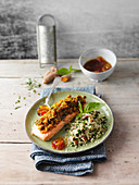 Salmon with a turmeric and herb crust served with almond bulgur