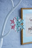 Snowflake made from stitched paper shapes
