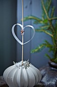 Paper heart on stick in vase with structured surface
