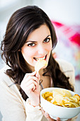 Woman eating potato chips