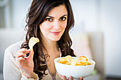 Woman eating potato chips