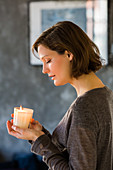 Woman holding scented candle