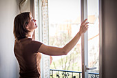 Woman opening window