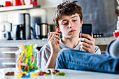 Teenage boy eating sweets