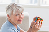 Senior woman playing with a Rubik's cube