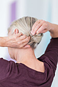 Woman tying her hair