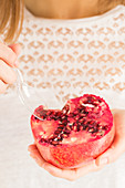 Woman eating pomegranate