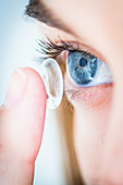 Woman putting in a contact lens