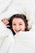 Teenage girl resting in bed