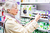 Senior woman shopping in pharmacy