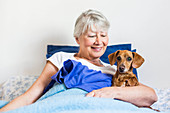 Senior woman resting with her dog