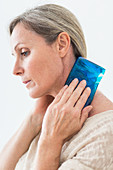 Woman using a hot-cold gel pack
