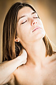 Woman suffering from neck pain