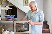 Man using a microwave oven