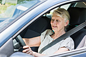 Senior driving her car