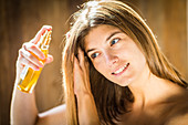 Woman applying oil on the hair